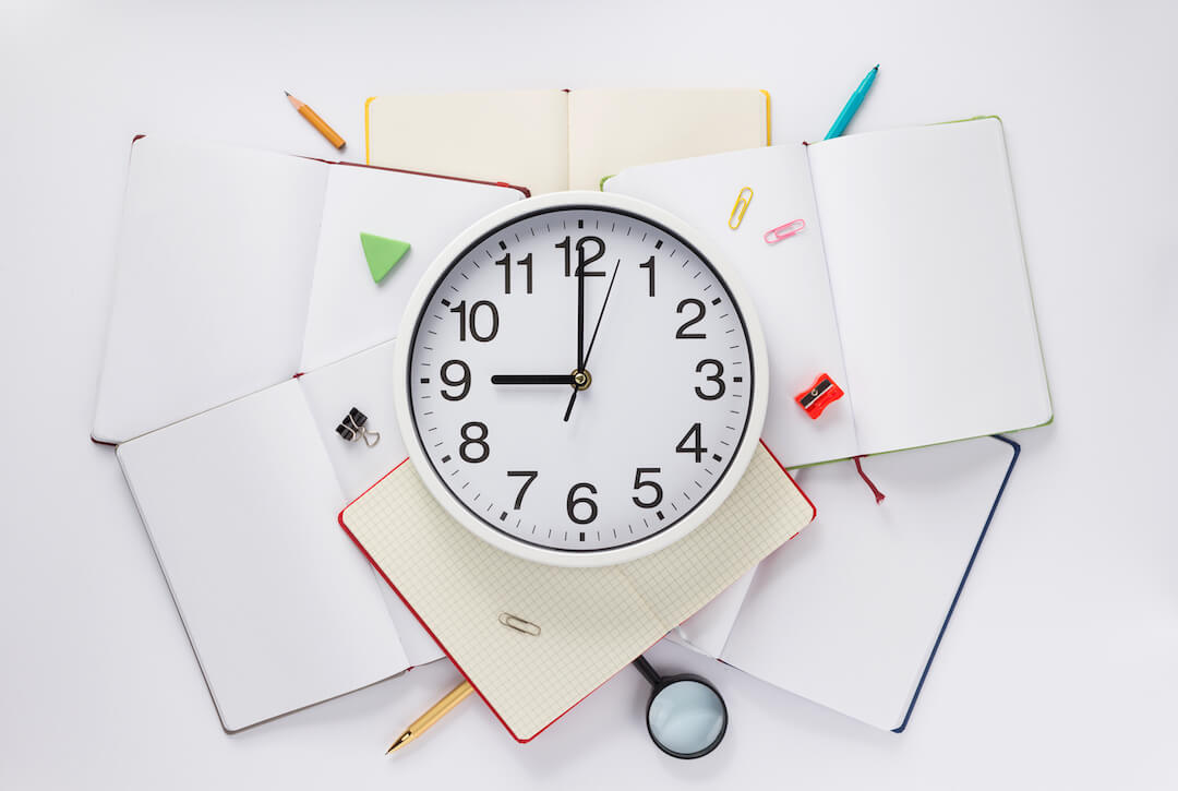 school-accessories-and-wall-clock-at-notebook-N7YVM3X
