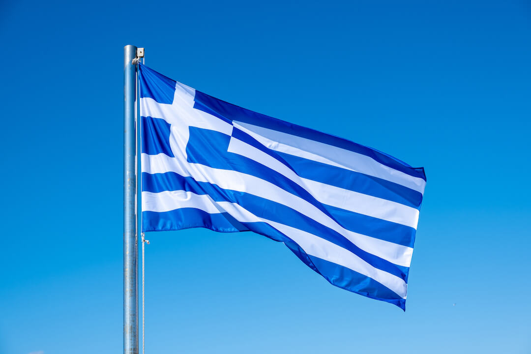 greek-flag-waving-against-blue-sky-background-2021-08-29-12-15-17-utc