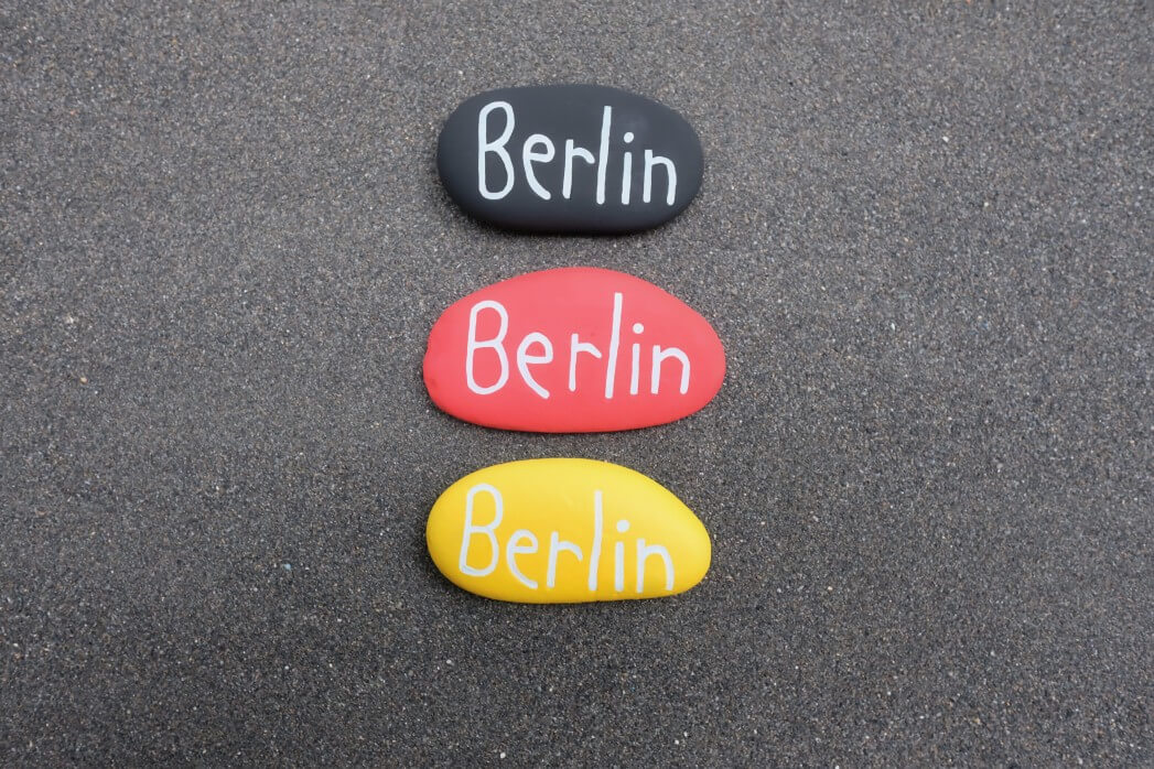souvenir-of-berlin-with-three-stones-with-the-national-flag-colors-over-black-volcanic-sand_t20_a77g1E-2
