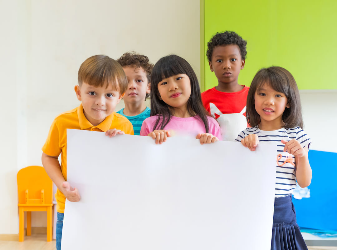 diversity-children-holding-blank-poster-in-classro-2021-12-09-07-32-19-utc-2
