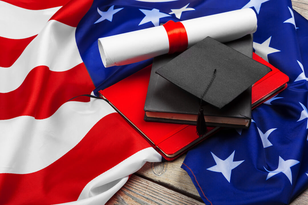 graduation-hat-on-us-flag-education-concept-2021-12-21-19-21-10-utc-2