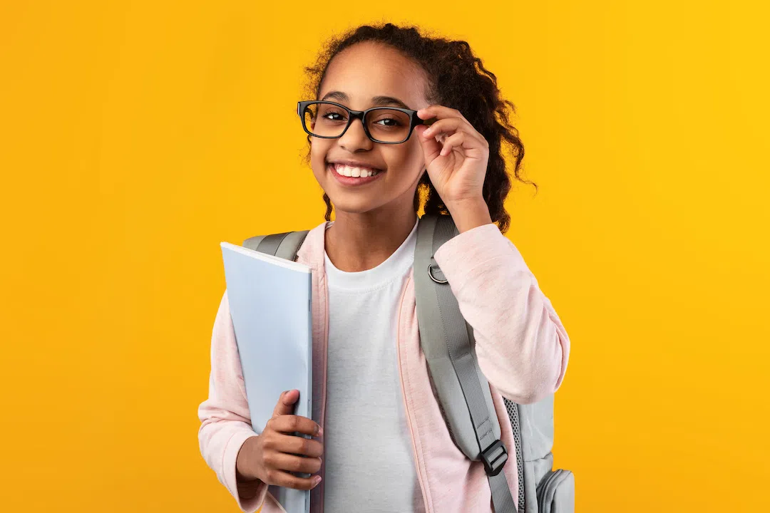 cheerful-young-black-girl-holding-textbooks-lookin-2022-02-07-09-09-34-utc