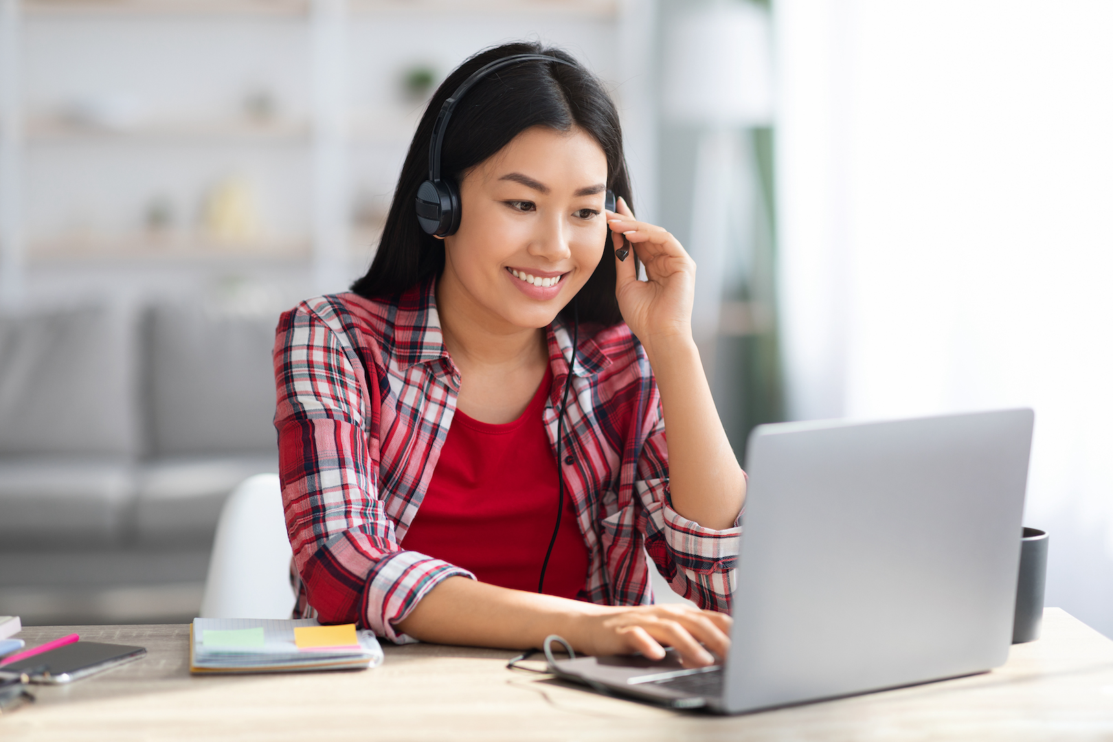 Distance Learning. Cheerful Asian Woman In Headset Studying With Laptop At Home
