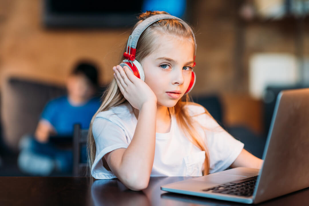 little-girl-in-headphones-with-laptop-on-tabletop-2022-11-12-00-53-54-utc copy