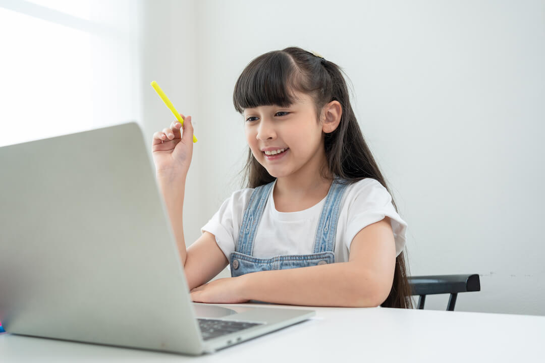 smiling-asian-little-girl-using-laptop-doing-homew-2023-01-20-02-07-41-utc-2