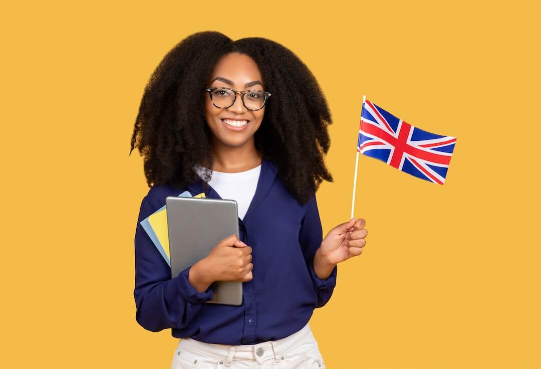 smiling-black-student-with-uk-flag-and-tablet-on-y-2023-12-14-04-38-03-utc-2