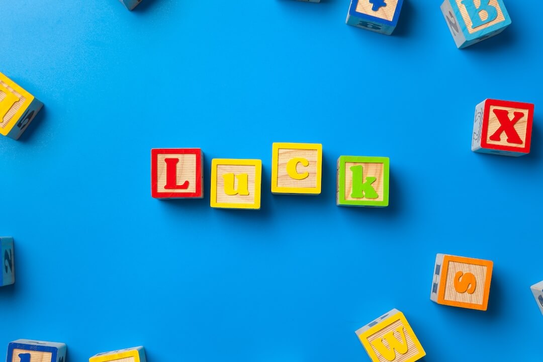luck-wooden-colorful-alphabet-blocks-on-blue-back-2023-11-27-04-52-54-utc-2