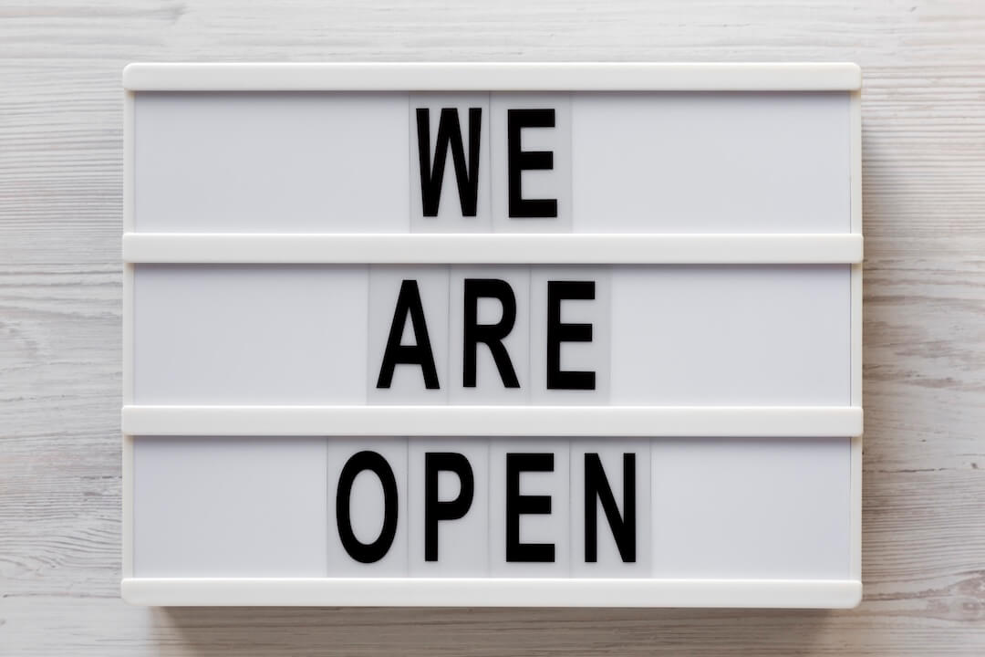 we-are-open-text-on-a-lightbox-on-a-white-wooden-2024-10-20-16-11-30-utc-2